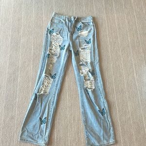 These cute jeans are covered in adorable butterflies and super stylish rips